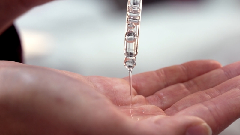 Niacinamide serum applied by dropper during a skincare routine with tretinoin