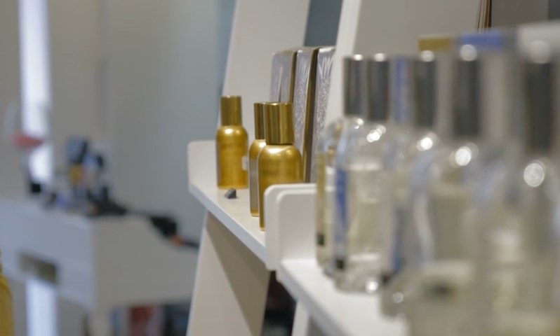 Stylish display of gold and silver-topped bottles on modern white shelves