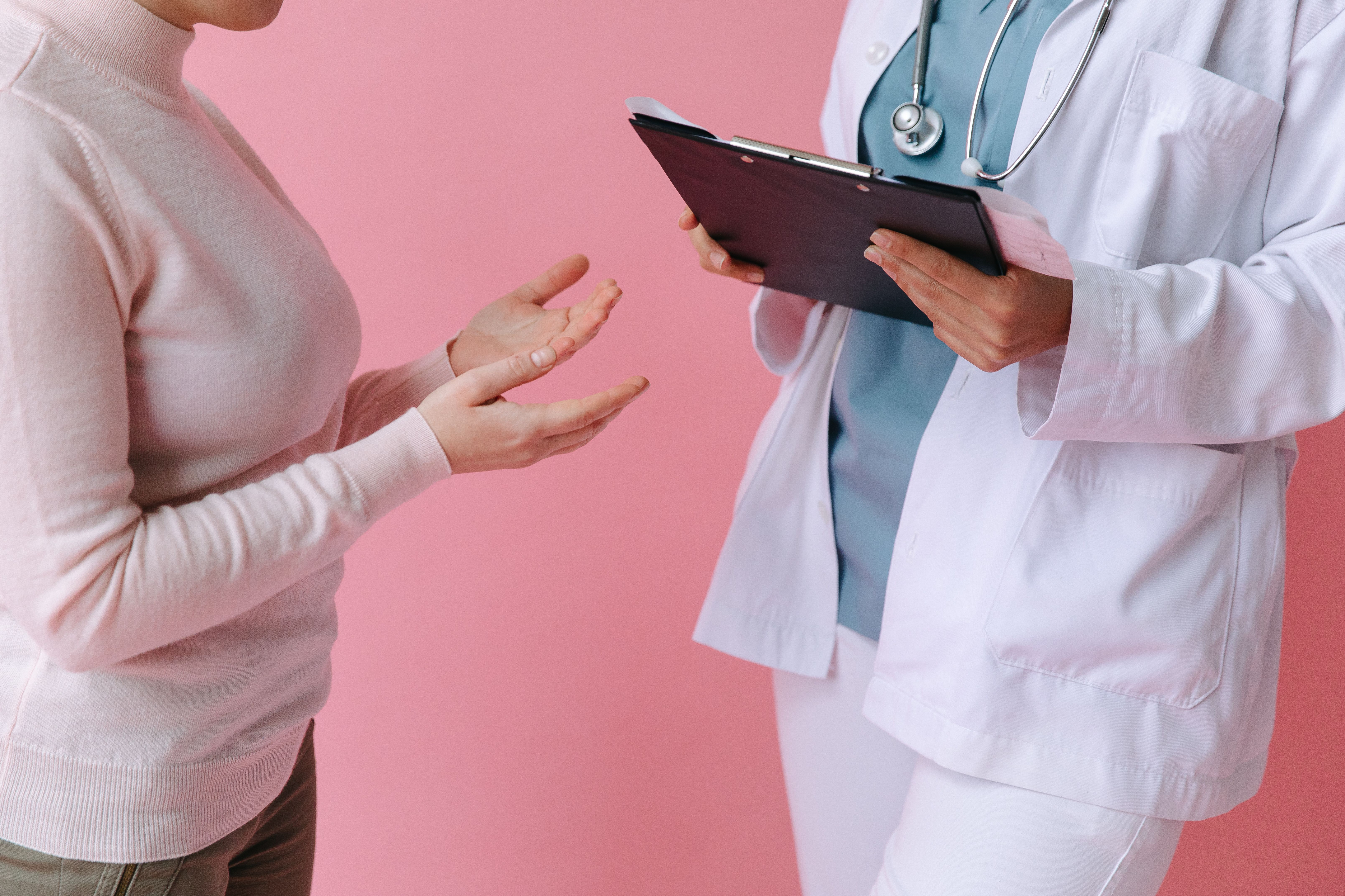 Patient consulting a doctor in a medical setting, illustrating personalized care for hormonal and skin health.